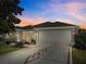 Charming single Gathering home featuring a large driveway, a two-car garage, and manicured landscaping at 737 Caldwell Ct, The Villages, FL 32162
