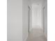 Bright hallway featuring neutral tiling and classic white walls, connecting different areas of the home seamlessly at 737 Caldwell Ct, The Villages, FL 32162