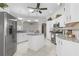 Beautiful kitchen featuring white cabinets, stainless steel appliances, granite countertops and large island at 737 Caldwell Ct, The Villages, FL 32162
