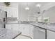 White cabinets and stainless steel appliances in kitchen with granite countertops and subway tile backsplash at 737 Caldwell Ct, The Villages, FL 32162
