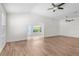 Spacious living room with vaulted ceilings, hardwood floors, ceiling fan and natural light at 737 Caldwell Ct, The Villages, FL 32162