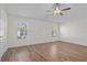 Empty main bedroom boasts hardwood floors, neutral walls, and ceiling fan at 737 Caldwell Ct, The Villages, FL 32162
