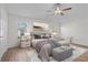 Beautifully staged main bedroom with a large bed, modern décor, and lots of natural light at 737 Caldwell Ct, The Villages, FL 32162