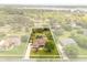 Aerial view outlines property, showcasing lush landscaping and inviting pool at 7636 Lake Angelina Dr, Mount Dora, FL 32757