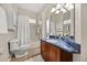 This bathroom offers a shower/tub combo and vanity with a blue countertop at 7636 Lake Angelina Dr, Mount Dora, FL 32757