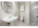 Bright bathroom featuring a pedestal sink and a walk in shower at 7636 Lake Angelina Dr, Mount Dora, FL 32757