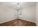 This bedroom has wood flooring, base trim, and two windows at 7636 Lake Angelina Dr, Mount Dora, FL 32757