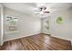 This bedroom has hard wood floors, large windows, decorative ceiling fan, and neutral paint at 7636 Lake Angelina Dr, Mount Dora, FL 32757