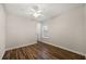 This bedroom has wood flooring and a hall door with a window at 7636 Lake Angelina Dr, Mount Dora, FL 32757
