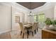 Inviting dining room featuring a wooden table, upholstered chairs, and natural light from a nearby window at 7636 Lake Angelina Dr, Mount Dora, FL 32757