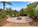 A welcoming backyard featuring a fire pit and a shaded pergola at 7636 Lake Angelina Dr, Mount Dora, FL 32757