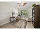 Bright home office with large windows, ceiling fan, neutral paint, and decorative rug at 7636 Lake Angelina Dr, Mount Dora, FL 32757