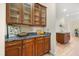 Kitchen with wood cabinets, stone counter tops, and stainless hardware at 7636 Lake Angelina Dr, Mount Dora, FL 32757