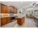 Stylish kitchen featuring stainless steel appliances, a center island, and ample cabinet storage at 7636 Lake Angelina Dr, Mount Dora, FL 32757