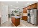 Open kitchen with stainless steel appliances, an island, and views of the dining area at 7636 Lake Angelina Dr, Mount Dora, FL 32757