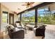 Inviting outdoor living space with comfortable seating overlooking the pool and serene backyard at 7636 Lake Angelina Dr, Mount Dora, FL 32757