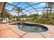 Stunning pool featuring a waterfall and screened enclosure at 7636 Lake Angelina Dr, Mount Dora, FL 32757