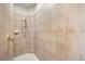 Tiled shower with gold hardware and a shower head at 7636 Lake Angelina Dr, Mount Dora, FL 32757