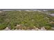 An aerial view shows a sprawling wooded area with scattered homes and a visible roadway at 801 Kilgore St, Wildwood, FL 34785