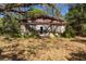 Charming stone cottage exterior featuring a vintage design and lush greenery at 801 Kilgore St, Wildwood, FL 34785