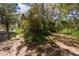 Exterior featuring a home nearly hidden in the lush overgrowth and shaded areas at 801 Kilgore St, Wildwood, FL 34785