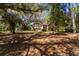 A stone cottage surrounded by trees provides a unique fixer-upper opportunity at 801 Kilgore St, Wildwood, FL 34785