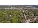 An aerial view of a vacant lot is surrounded by mature trees, and bordered by a road at 801 Kilgore St, Wildwood, FL 34785
