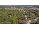 An aerial view of a vacant lot is surrounded by mature trees, and bordered by a road at 801 Kilgore St, Wildwood, FL 34785