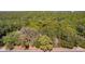A vacant lot is surrounded by mature trees, offering privacy at 801 Kilgore St, Wildwood, FL 34785