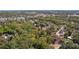 An aerial view of a vacant lot is surrounded by mature trees, and bordered by a road at 801 Kilgore St, Wildwood, FL 34785