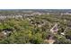 An aerial view of a vacant lot is surrounded by mature trees, and bordered by a road at 801 Kilgore St, Wildwood, FL 34785
