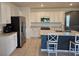 Well-lit kitchen with tile floors, a stainless steel refrigerator, and a large island with barstool seating at 808 Brooklet Dr, Davenport, FL 33837