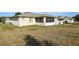 View of the home's exterior, screened lanai, and large backyard needing landscape at 9857 Sw 63Rd Ct, Ocala, FL 34476