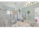 Well-lit bathroom featuring a glass-enclosed shower, vanity, and updated fixtures at 9857 Sw 63Rd Ct, Ocala, FL 34476