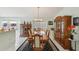 A formal dining room with a wooden table, seating for eight, and elegant china cabinets at 9857 Sw 63Rd Ct, Ocala, FL 34476