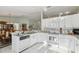 Open-concept kitchen featuring white cabinetry, modern appliances, and a seamless flow to the dining area at 9857 Sw 63Rd Ct, Ocala, FL 34476