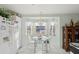 Charming breakfast nook with a glass-top table, seating for two, and bright natural light from the bay window at 9857 Sw 63Rd Ct, Ocala, FL 34476