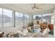 Cozy sunroom with abundant natural light, ceiling fan, and comfortable seating at 9857 Sw 63Rd Ct, Ocala, FL 34476