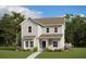 Charming two-story home with a blue front door and beautiful landscaping at 9905 Gobat Aly, Orlando, FL 32827