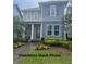 Charming two-story home with manicured lawn and lush landscaping enhancing curb appeal at 9905 Gobat Aly, Orlando, FL 32827