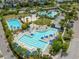 Aerial view of a refreshing pool area featuring lounge chairs, umbrellas, and palm trees, offering a relaxing oasis at 9905 Gobat Aly, Orlando, FL 32827