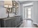 Bright entryway featuring a stylish console table, tasteful artwork, and a glass-paneled front door at 12160 Keystone Pass Blvd, Minneola, FL 34715