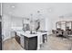 Stylish kitchen with quartz countertops, stainless steel appliances, and a seamless connection to the dining area at 12160 Keystone Pass Blvd, Minneola, FL 34715