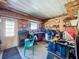 Workshop featuring tools, storage shelves, work bench, plywood interior, and a door to the exterior at 1308 Mohawk Cir, Tavares, FL 32778
