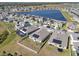 Aerial view of the community featuring solar panels on roofs and a scenic pond at 197 Pineywoods St, St Cloud, FL 34772