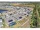 Aerial view of neighborhood featuring pond, solar panels and fenced yards at 197 Pineywoods St, St Cloud, FL 34772