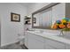 Bathroom featuring white vanity, gray floor tiles, and decorative wall shelves at 197 Pineywoods St, St Cloud, FL 34772