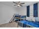 bedroom with carpet, bunk beds with blue comforters and a ceiling fan at 197 Pineywoods St, St Cloud, FL 34772