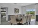 Dining room featuring a modern table set with plush upholstered chairs and views of the landscaped backyard at 197 Pineywoods St, St Cloud, FL 34772