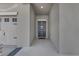 Covered entryway featuring a front door with wreath decor, adjacent to the garage door and driveway at 197 Pineywoods St, St Cloud, FL 34772